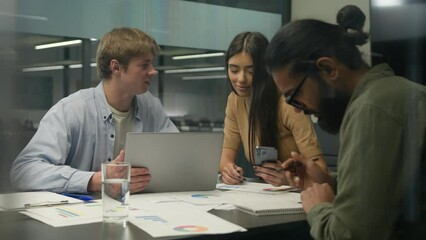 Multiracial business partners co-workers talk discussion female male colleagues businesswoman businessmen partnership Arabian Caucasian men woman teamwork cooperation use laptop phone office boardroom