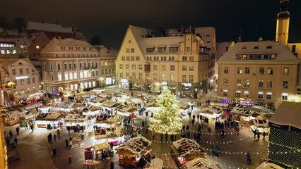 Christmas decoration in the main square in Tallin, the christmas tree and the stores full of people, chrstmas market