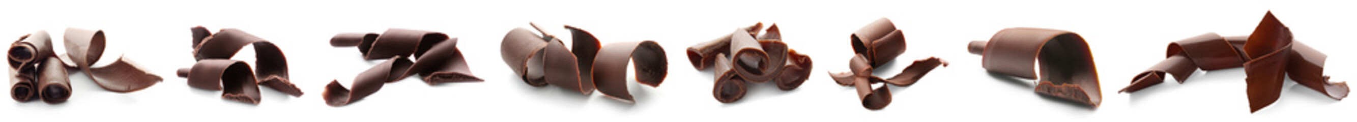 Set of sweet chocolate curls on white background