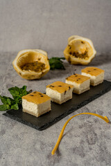 Sweet homemade passion fruit cakes on black flagstone