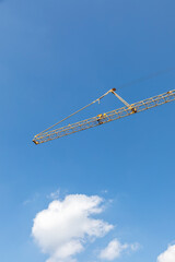 big crane under clear blue sky as symbol for construction site