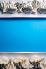 traditional georgian khinkali dumplings flatlay with copyspace, blue background