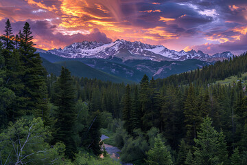 Stunning Mountain Sunrise with Snow-Capped Peaks and Dense Forest Reflecting in a Winding River