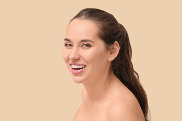 Happy young woman with natural makeup on color background
