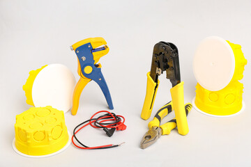 Electrician's tools on light background