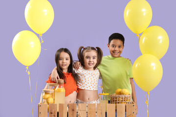 Cute little children hugging at lemonade stand on lilac background