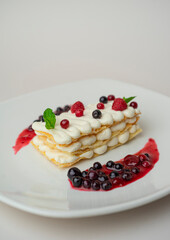 Light cottage cheese dessert with berries on a white background