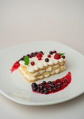 Light cottage cheese dessert with berries on a white background