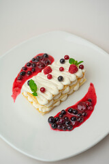 Light cottage cheese dessert with berries on a white background
