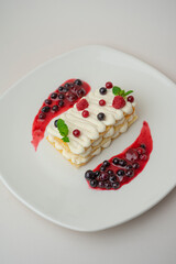 Light cottage cheese dessert with berries on a white background