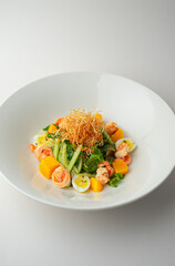 Warm shrimp salad on a white background