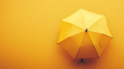 top view of a yellow umbrella on a bright background, with copy space for text