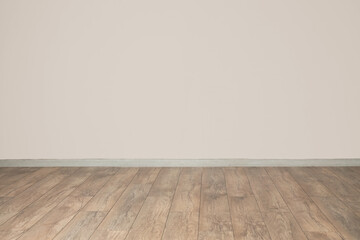 View of light wall and new wooden laminate in empty room