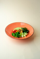 Bowl of vegetables on an orange plate
