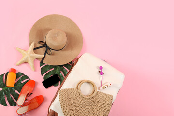 Composition with suitcase, beach accessories, mobile phone and sex toys on pink background