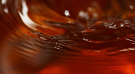 Macro shot of tea drink ripples as background