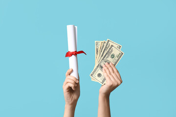 Female hands with diploma and money on blue background