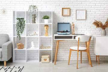Interior of living room with shelving unit, sofa and record player on coffee table