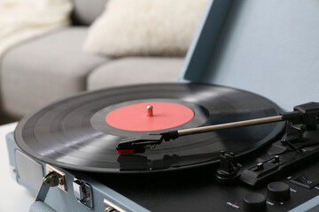 Record player with disk on coffee table in room, closeup