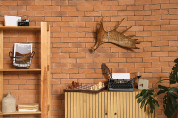 Interior of living room with moose antler and vintage typewriter on commode