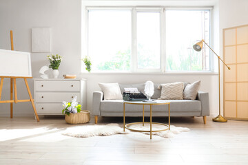 Interior of living room with sofa and vintage typewriter on table
