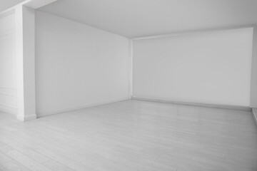 Empty room with white walls and laminated floor