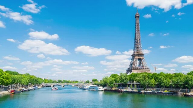 A timelapse of the Eiffel Tower along the river Seine with flyboats passing by with motion blur.Sunny but cloudy spring summer day paris city famous riverside bay tower view bridge timelapse panorama