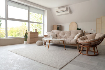 Interior of stylish living room with white sofa, armchair and coffee table