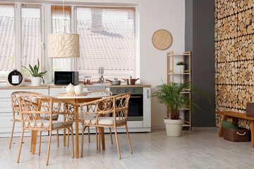 Interior of stylish kitchen with dining table, chairs, oven and lamp