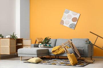 Interior of living room with messed furniture after strong earthquake