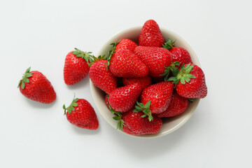 Bowl with sweet fresh strawberries on white background