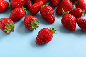 Sweet fresh strawberries on blue background