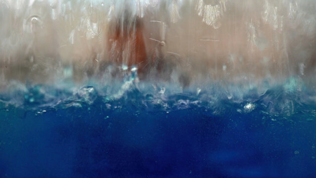 Moving blue liquid in glass tube at pharmacy lab, close up. Media. Concept of automated technology, chemistry, laboratory equipment.