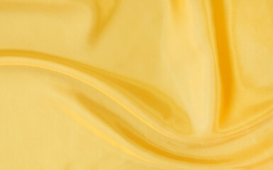 yellow gold satin texture that is white silver fabric luxurious shiny that is abstract silk cloth background with patterns soft waves blur beautiful.