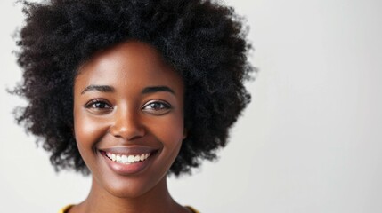 Beautiful african american woman smiling and looking at the camera in a fashionable portrait on a white background