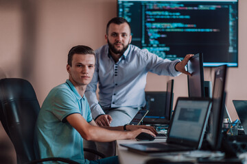 Programmers engrossed in deep collaboration, diligently working together to solve complex problems...