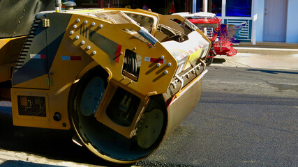 Road roller. A fragment of a skating rink laying fresh asphalt on the road.