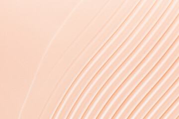Hyaluronic acid serum texture. Beauty skincare liquid gel background. Clear cosmetic cream on pink beige surface
