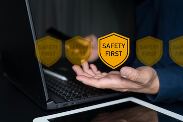 Safety first concept. Businessman using with safety first symbols for work safety.