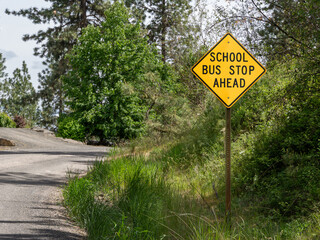 Outdoor "School Bus Stop Ahead" sign, located in the Pacific Northwest. Cheney, Washington