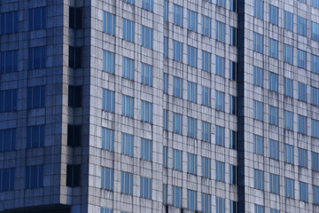 Obraz premium Big tall building background with windows and glass.
