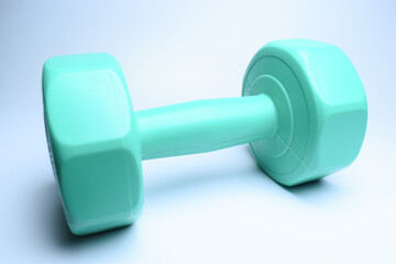 single green dumbbell on white background, object for exercise