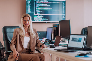 A businesswoman sitting in a programmer's office surrounded by computers, showing her expertise and...