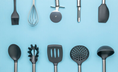 Assorted Modern Kitchen Utensils on Blue Background - High-Quality Cookware and Tools
