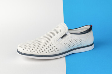 White Slip-On Shoe with Perforated Design on Split Blue and White Background