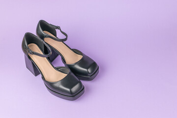 Black Block Heels with Ankle Strap on Purple Background in Stylish Fashion Footwear Display