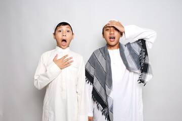 Two Young Asian Muslim Boys In Islamic Clothes Showing Shocked Surprise Expression