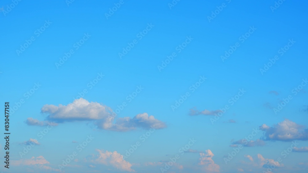 Wall mural a clear blue sky with a few scattered clouds. the clouds are primarily situated in the lower part of