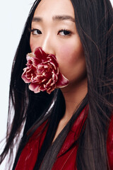 Beautiful Woman with Long Black Hair and Red Jacket Holding a Flower in Her Mouth