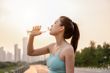Girls drink plenty of water to replenish fluids after exercising
